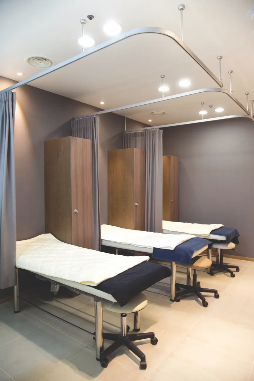 Three curtained treatment bays in the injection room at Gowoonmom Clinic
