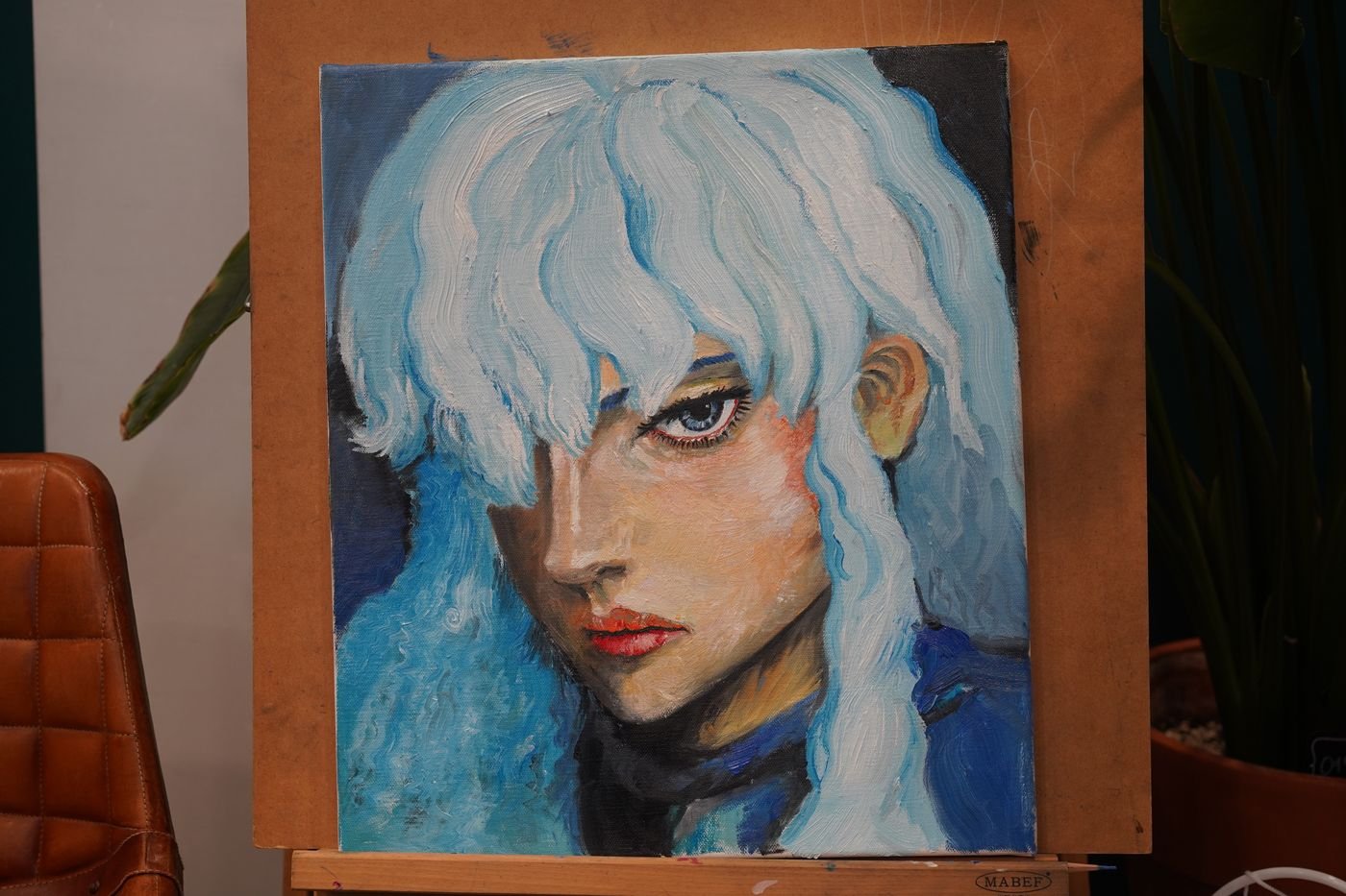 A portrait painted by the director of Motential Clinic, on an easel in the clinic