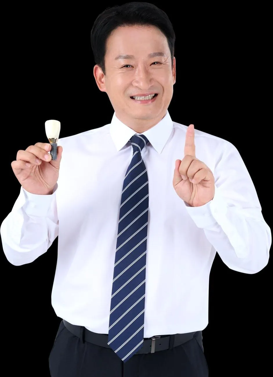 A dentist holding a single implant crown and abutment