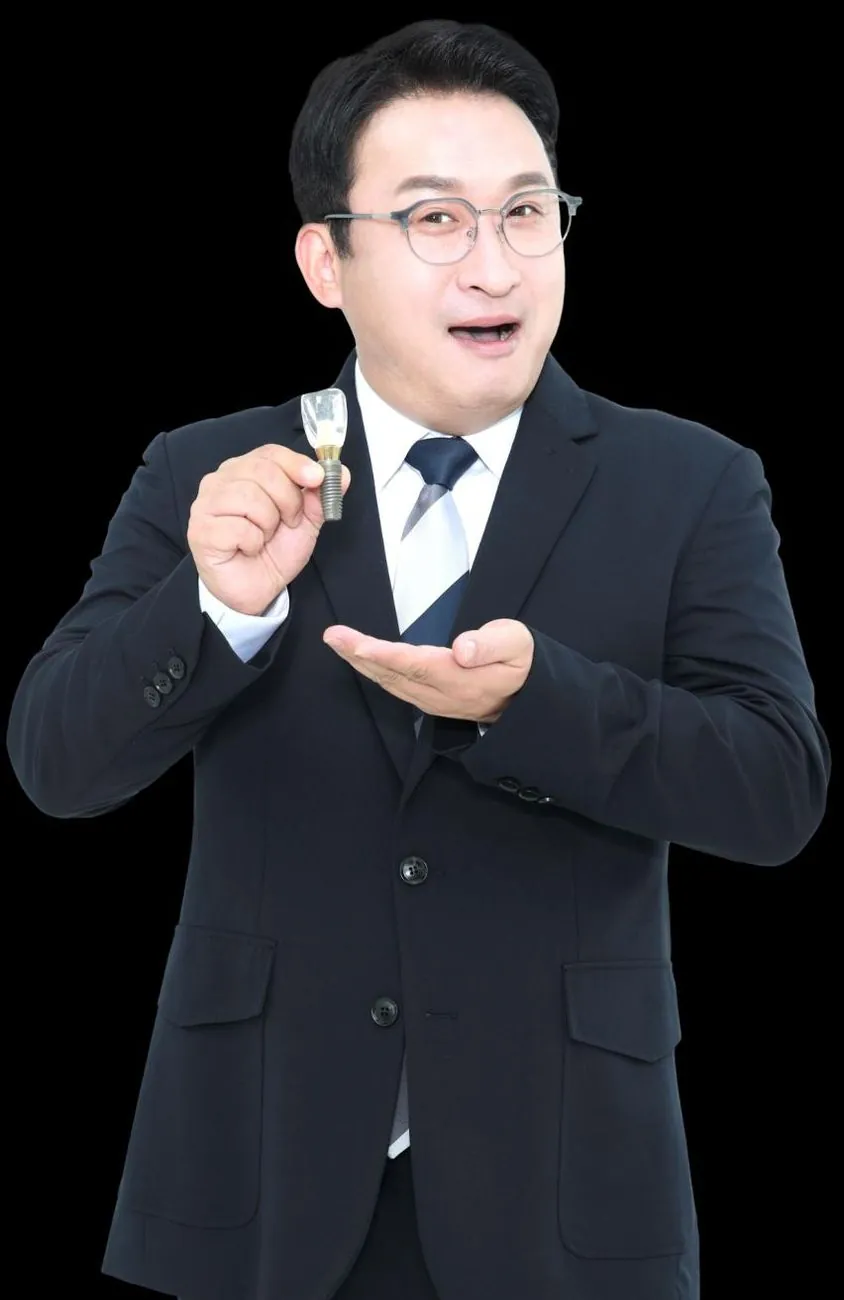 A dentist holding a single ceramic veneer